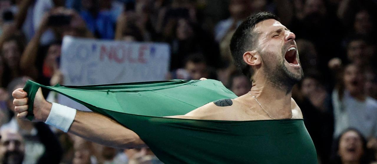 Novak Djokovic tears his jersey for joy