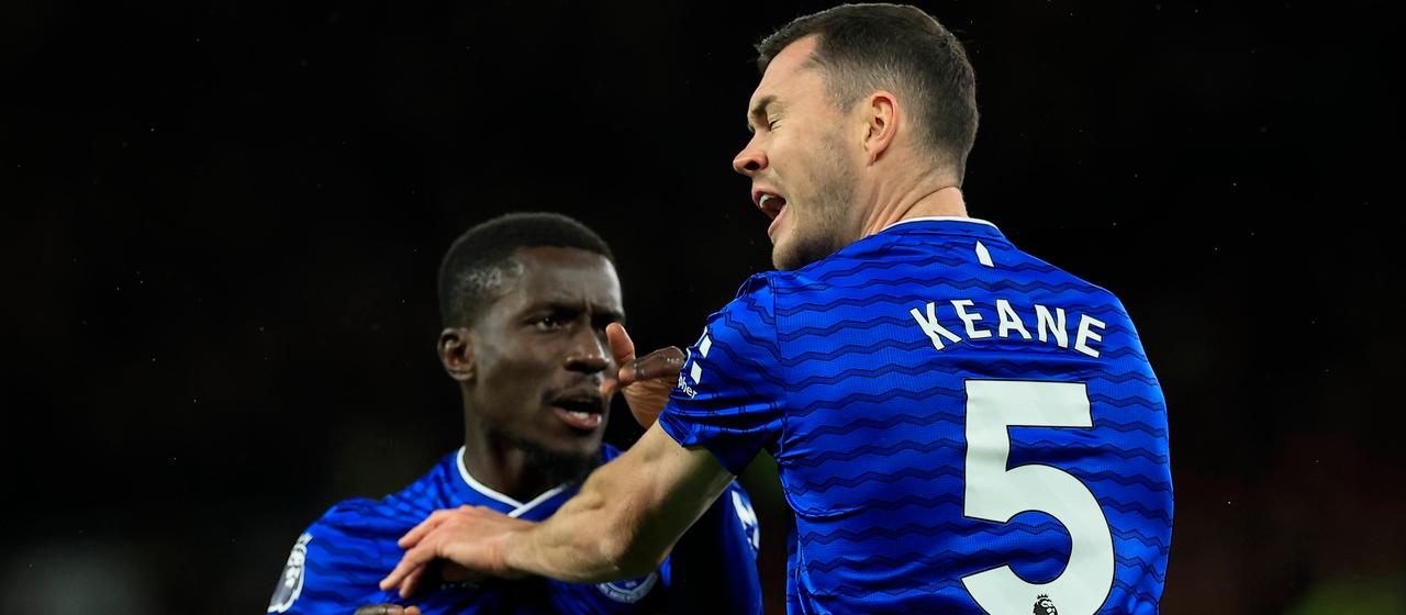 Idrissa Gueye (left) slaps teammate Michael Keane.