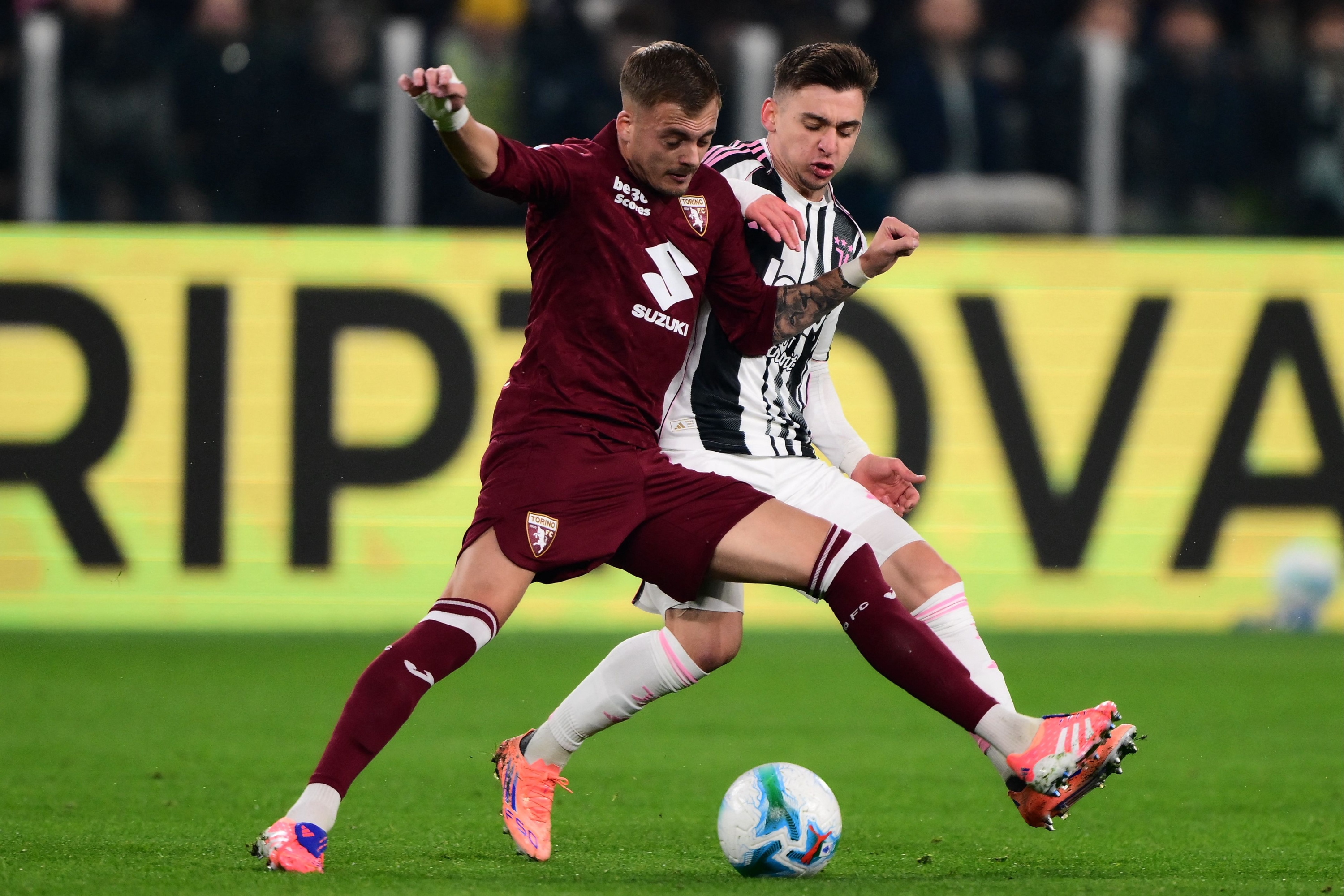 Torino's Serbian midfielder #8 Ivan Ilic fights for the ball with Juventus Portuguese forward #7 Francisco Conceicao (R) during the Italian Serie A football match between Juventus and Torino at the Allianz Stadium in Turin on November 8, 2025. (Photo by MARCO BERTORELLO / AFP)