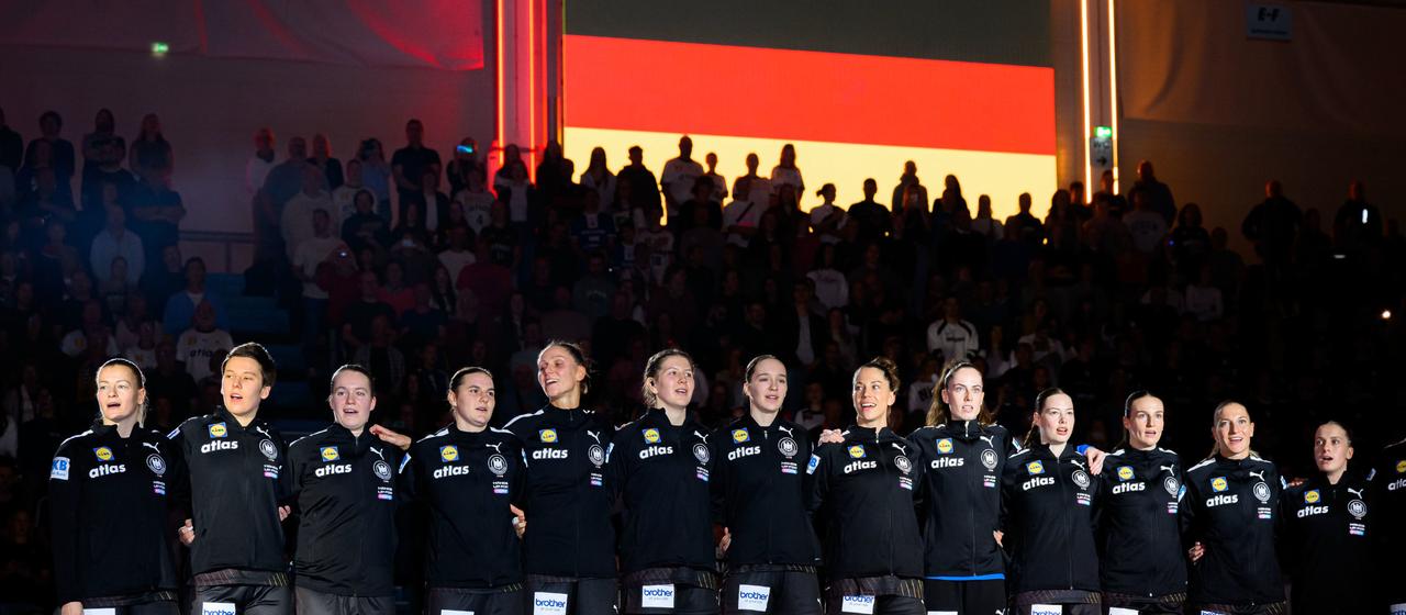 Germany's handball players sing the national anthem before the game