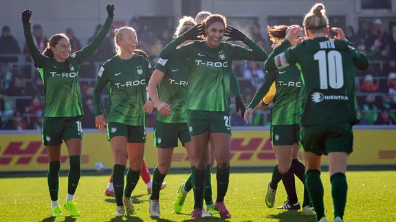 Wolfsburg's players celebrate a goal