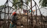 Neema Bihira, a resident of the Mugunga refugee camp, dismantles the frame of her shelter before preparing to return to her home village of Shasha. 