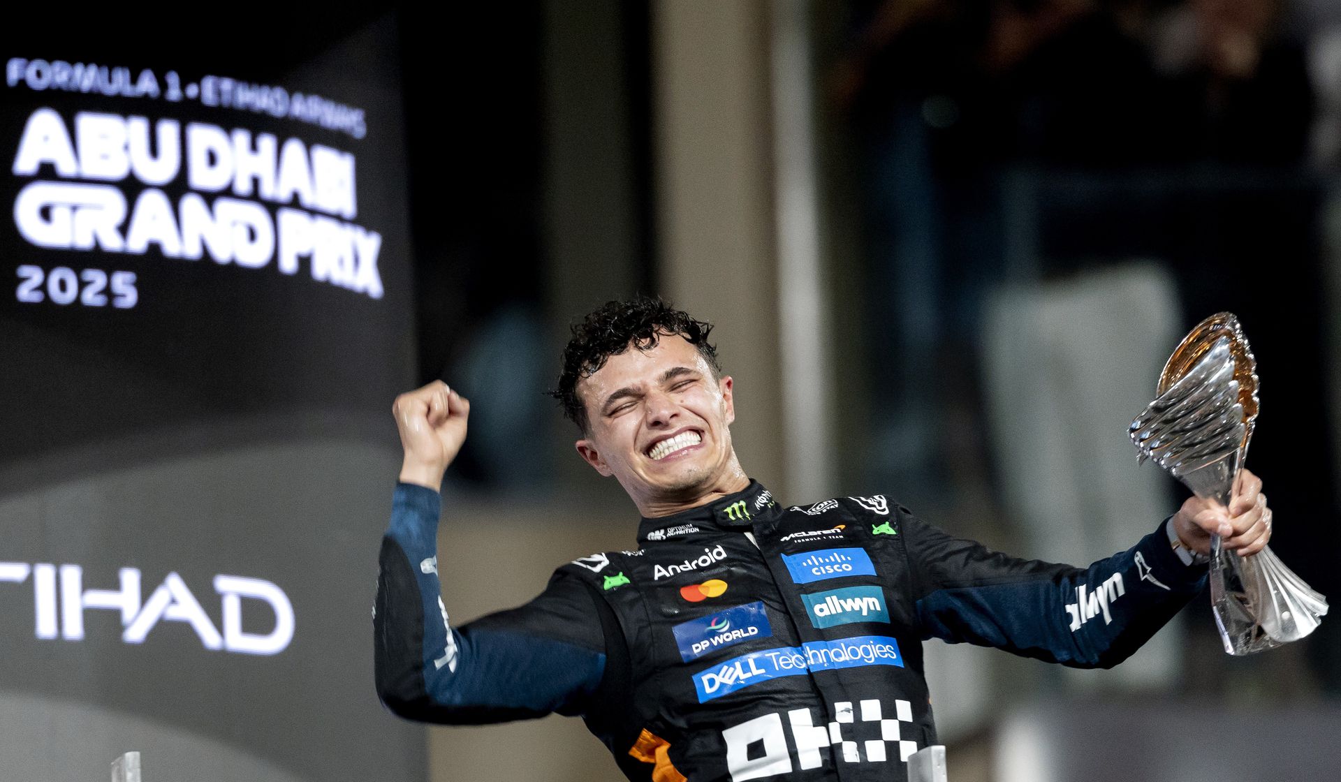 Lando Norris (McLaren) celebrates his world title on the podium of the Yas Marina Circuit.