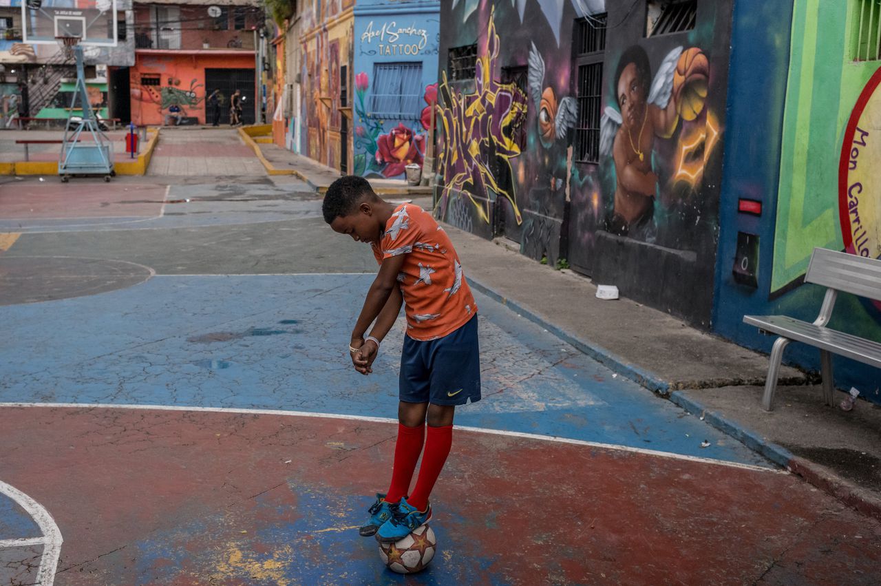 A boy plays with a soccer ball in the San Agustín slum in Caracas, December 2.