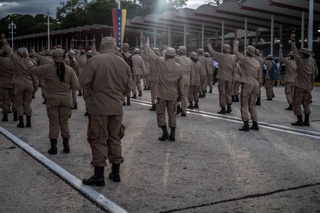 Venezuelan militia members walk in a government-organized civil-military march in Caracas, November 25. 