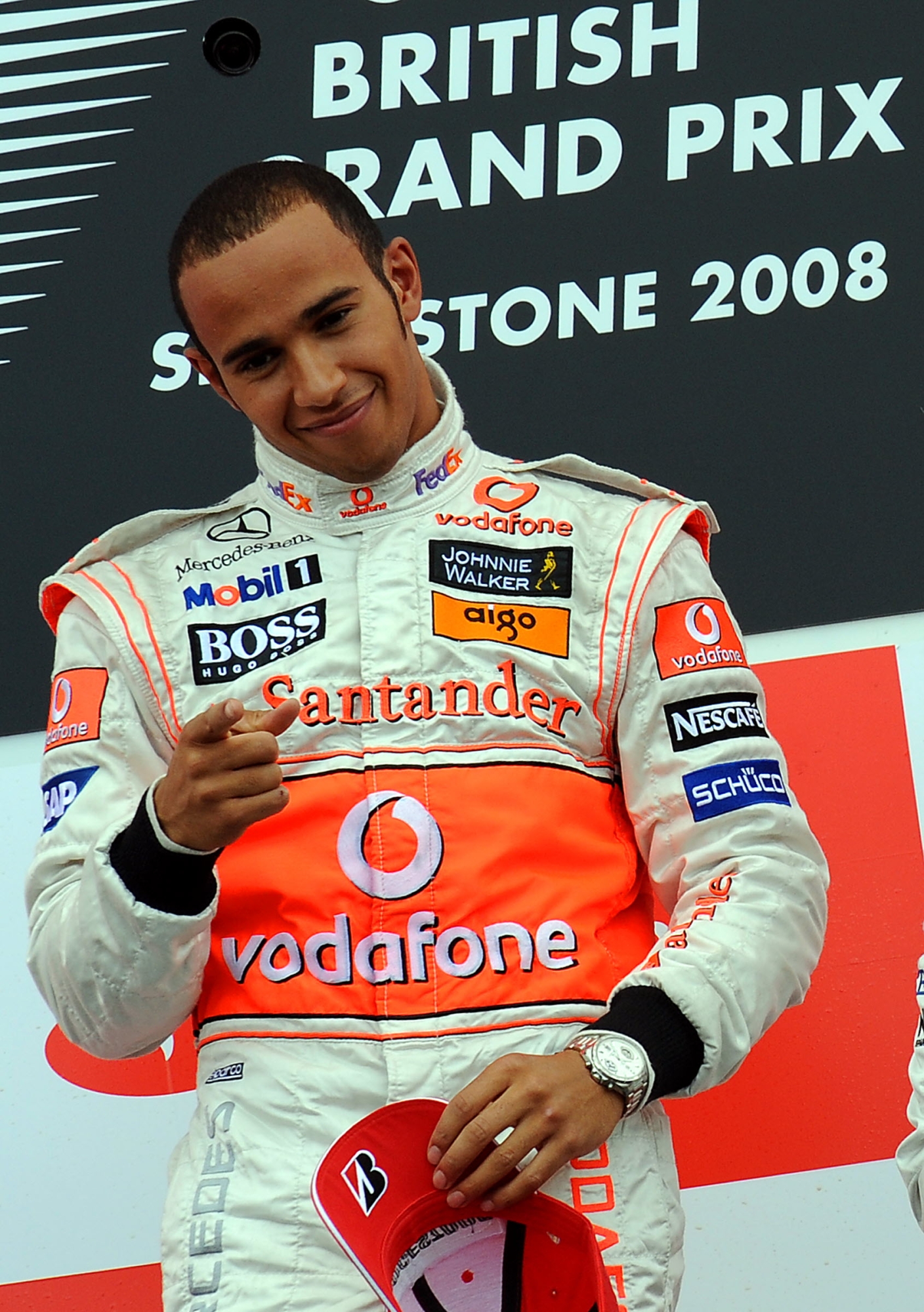McLaren Mercedes' British driver Lewis Hamilton celebrates on the podium of the Silverstone racetrack on July 6, 2008 in Silverstone, England, after the the Formula One British Grand Prix. McLaren Mercedes' British driver Lewis Hamilton won the race ahead of BMW Sauber's German driver Nick Heidfeld and Honda's Brazilian driver Rubens Barrichello. AFP PHOTO / BERTRAND GUAY