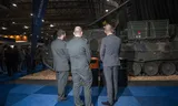 Soldiers view an army vehicle at the arms fair in Ahoy.  