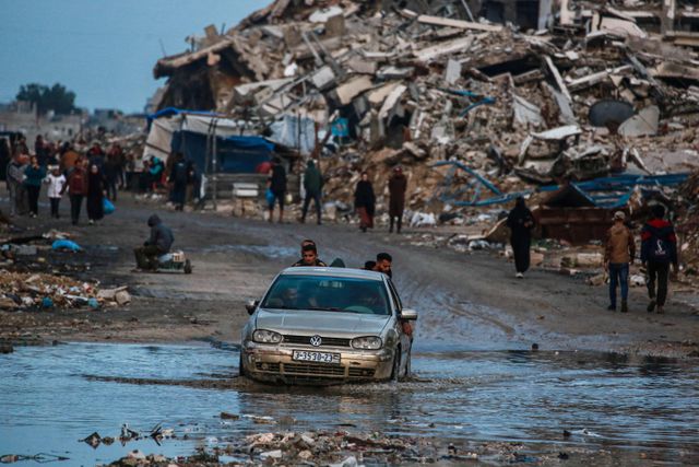 Palestinians in Gaza have to push through puddles of water. In Jabalia, in northern Gaza, a car drives through a large puddle. 