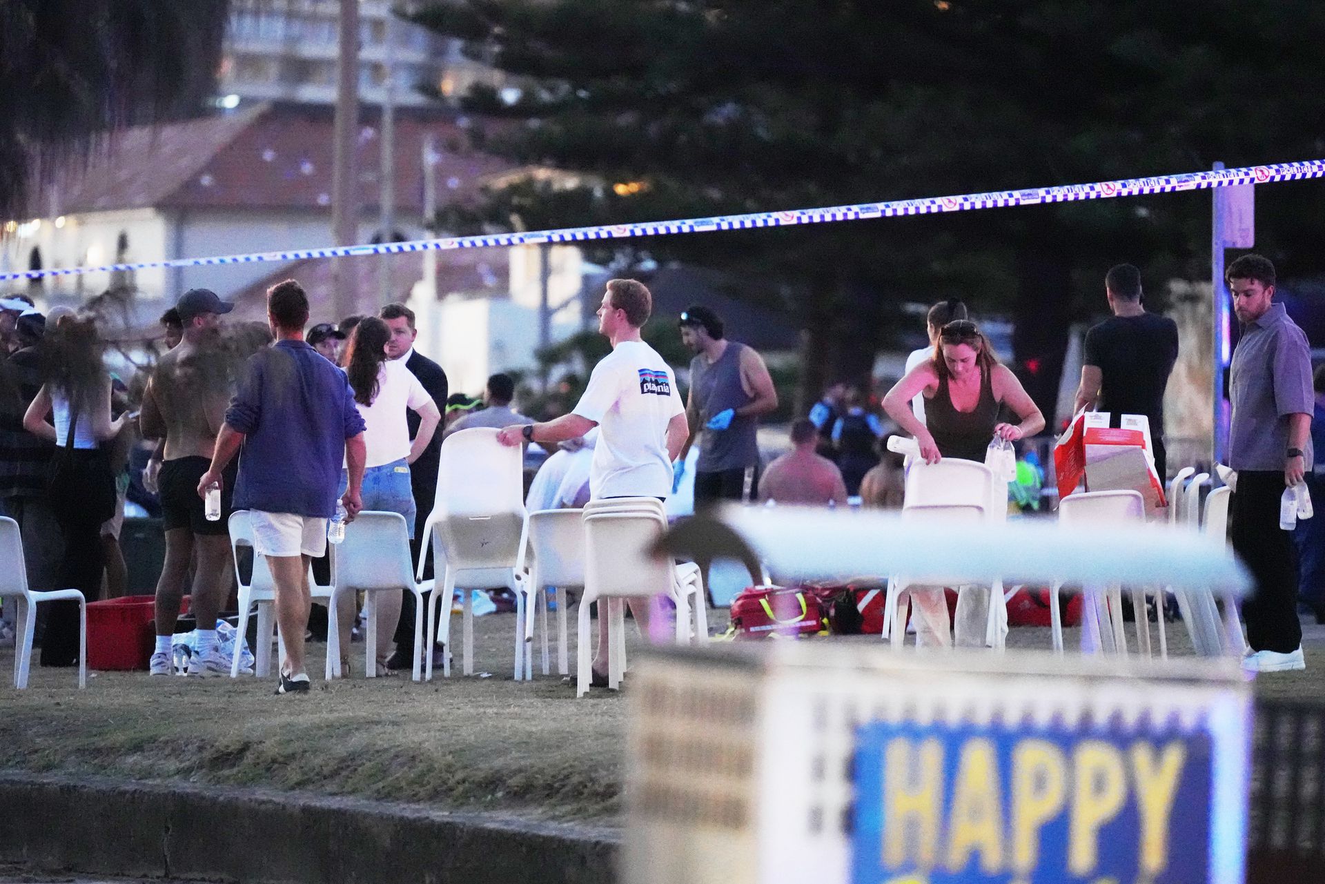 Emergency workers at the scene of the attack on a Jewish party on Sydney beach, which left at least twelve people dead.