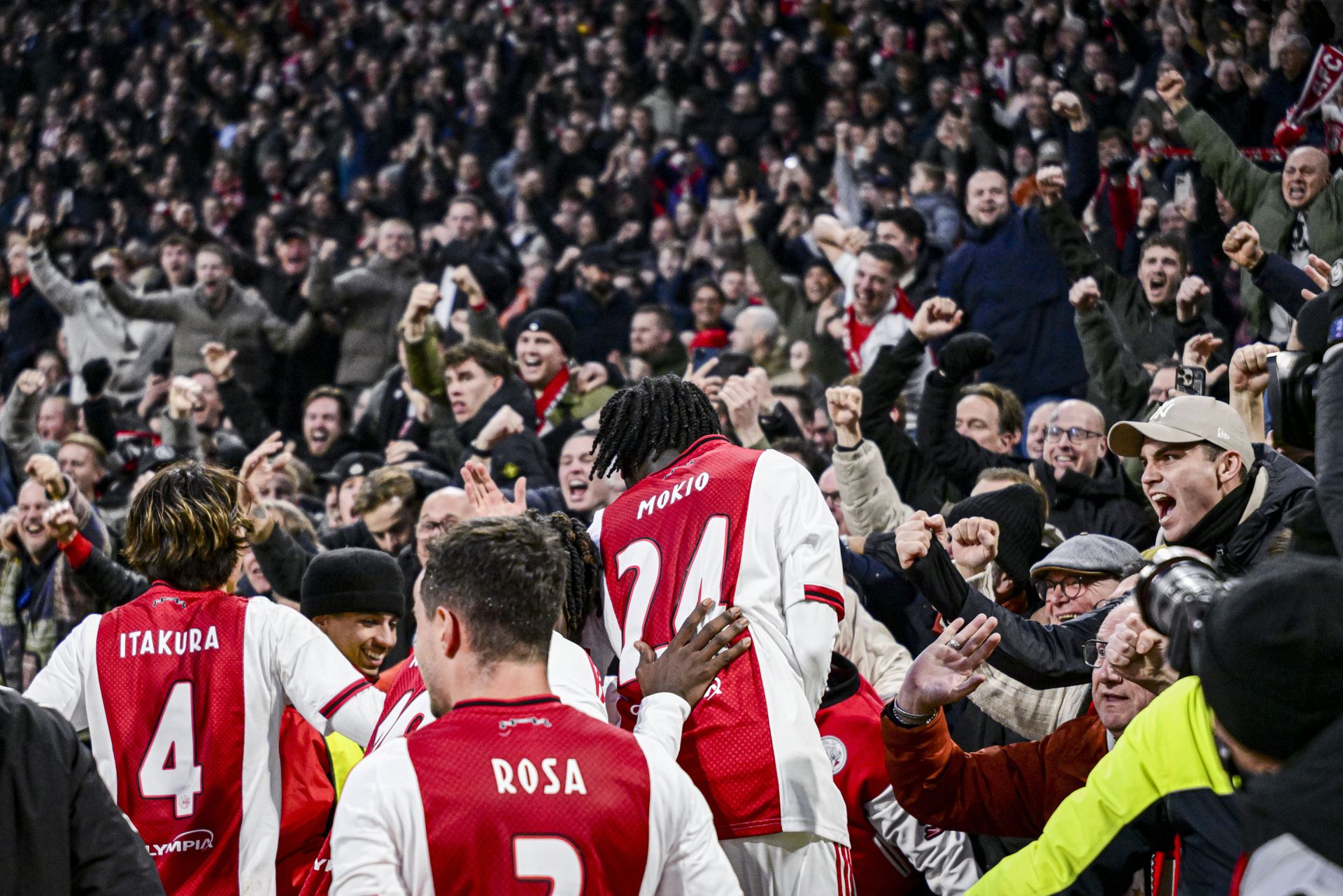Ajax players Ko Itakura, Lucas Rosa and Jorthy Mokio celebrate the 2-0 with the home fans.