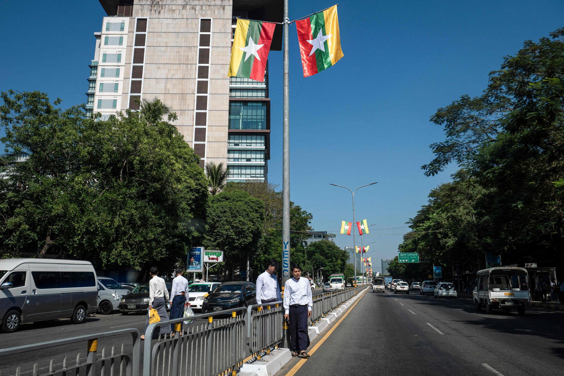 National flags hang from lampposts on the streets of Yangon in late December.