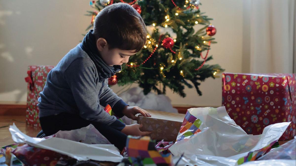 A child opens the Three Kings' gifts in a Spanish home.