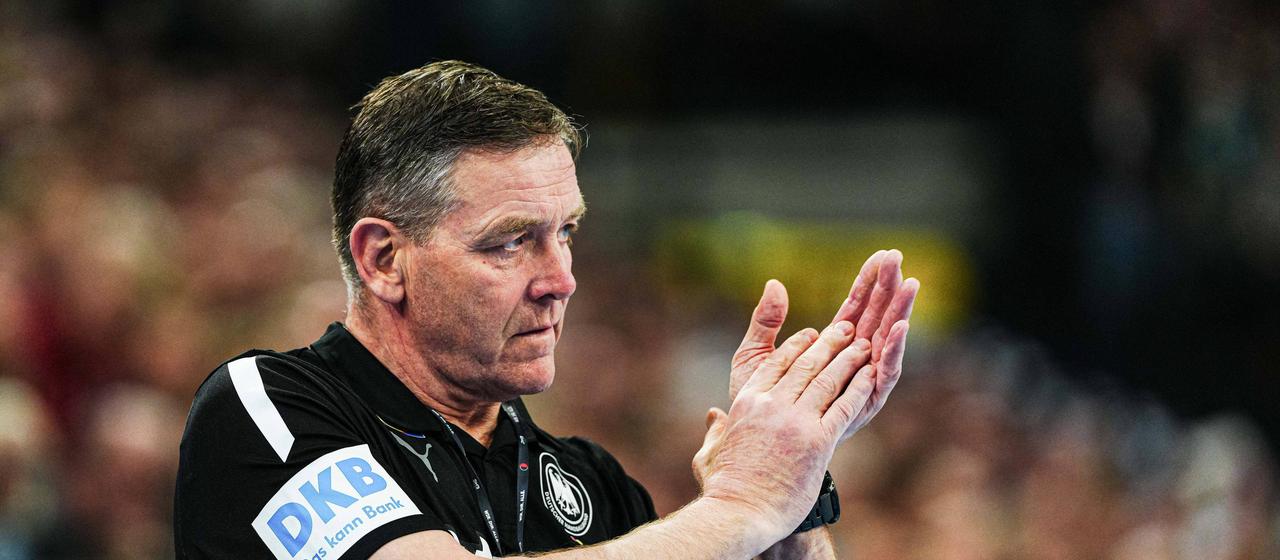 Germany's national handball coach Alfred Gislason claps his team