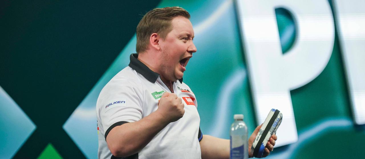 Martin Schindler celebrates after his first round match at the Darts World Cup