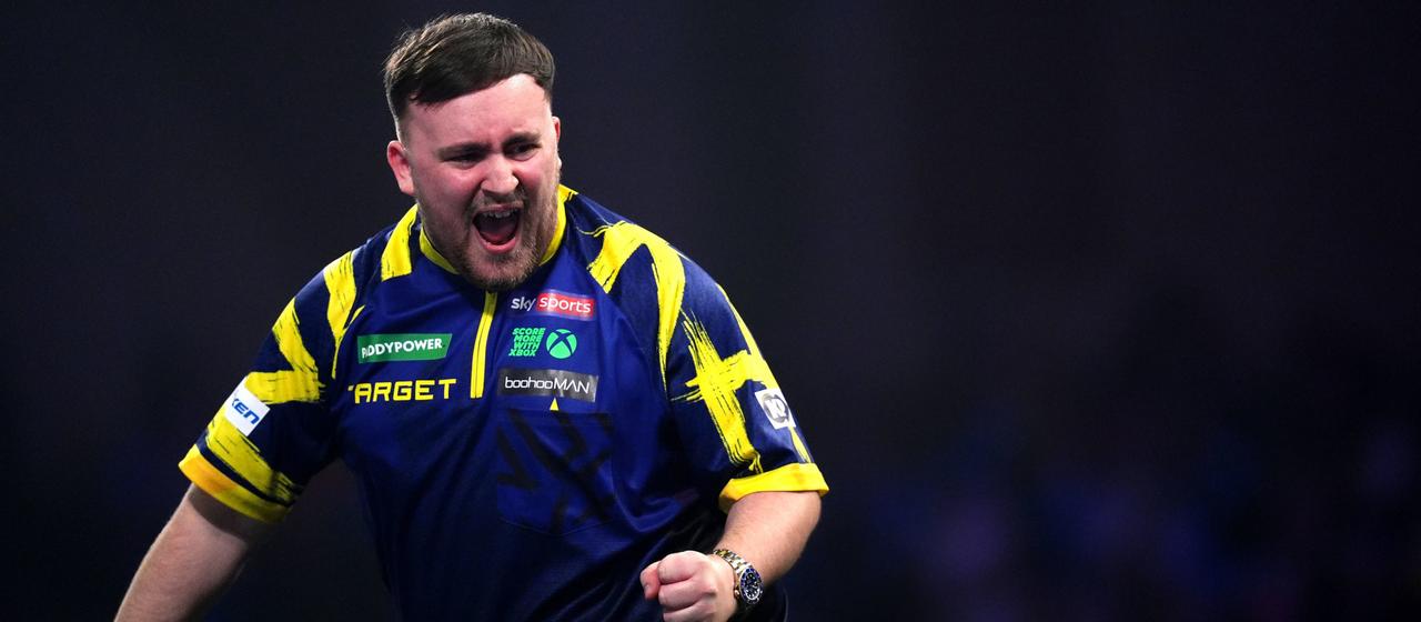 Luke Littler celebrates during the match against Rob Cross