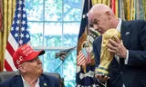 FIFA President Gianni Infantino hands over the World Cup to Donald Trump at the White House in Washington, August 22, 2025.  