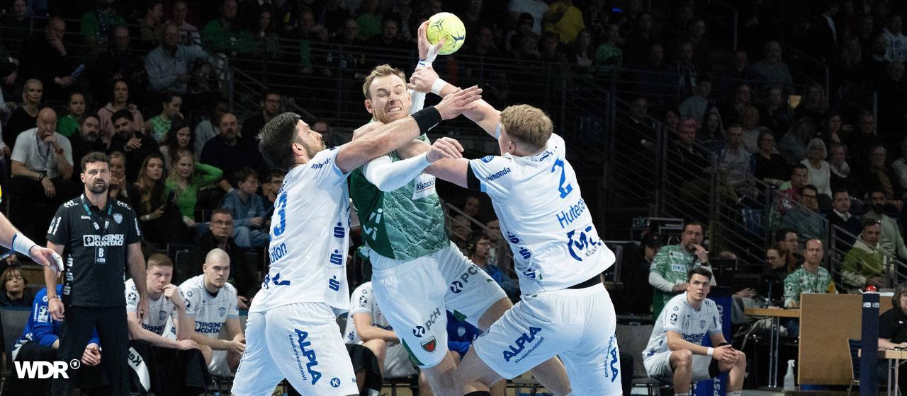 Tim Suton (left) and Lukas Hutecek (right) from trying to stop Berlin's Mathias Gidsel.