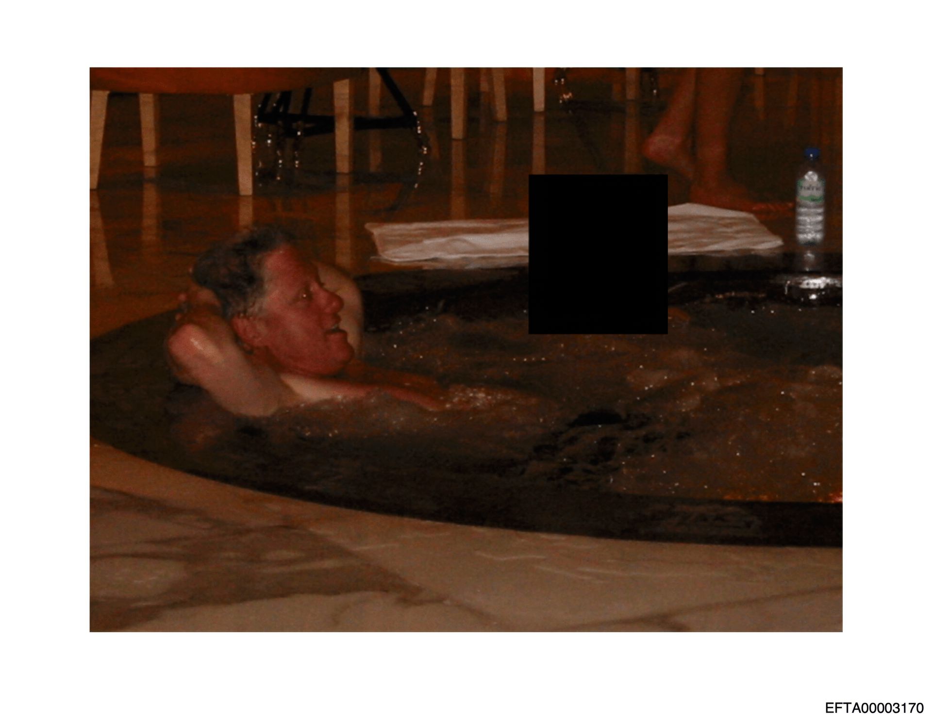 Undated photo of Bill Clinton in a hot tub with an unidentified woman.