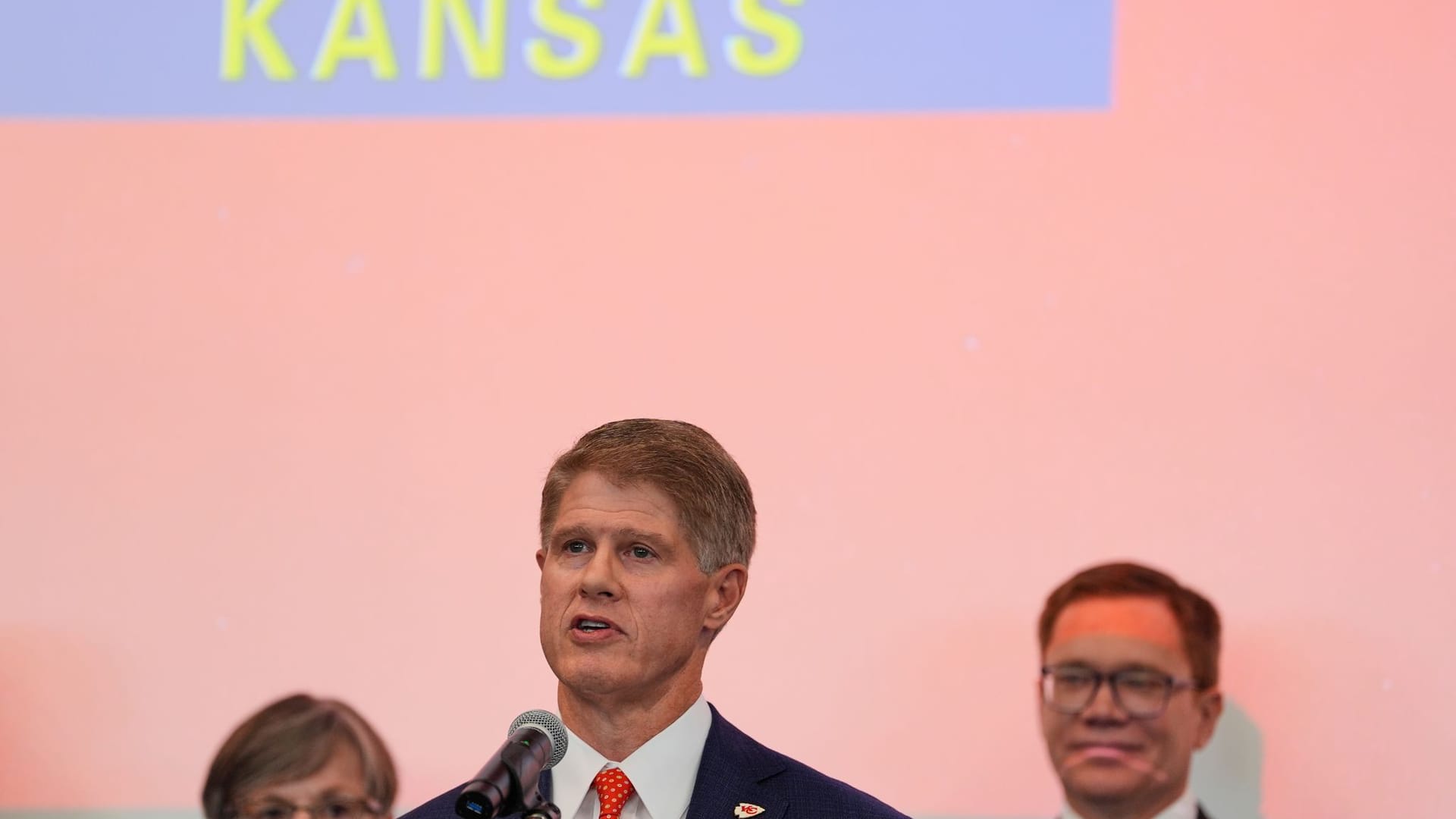 Kansas City Chiefs owner Clark Hunt (center) announces his team's move.