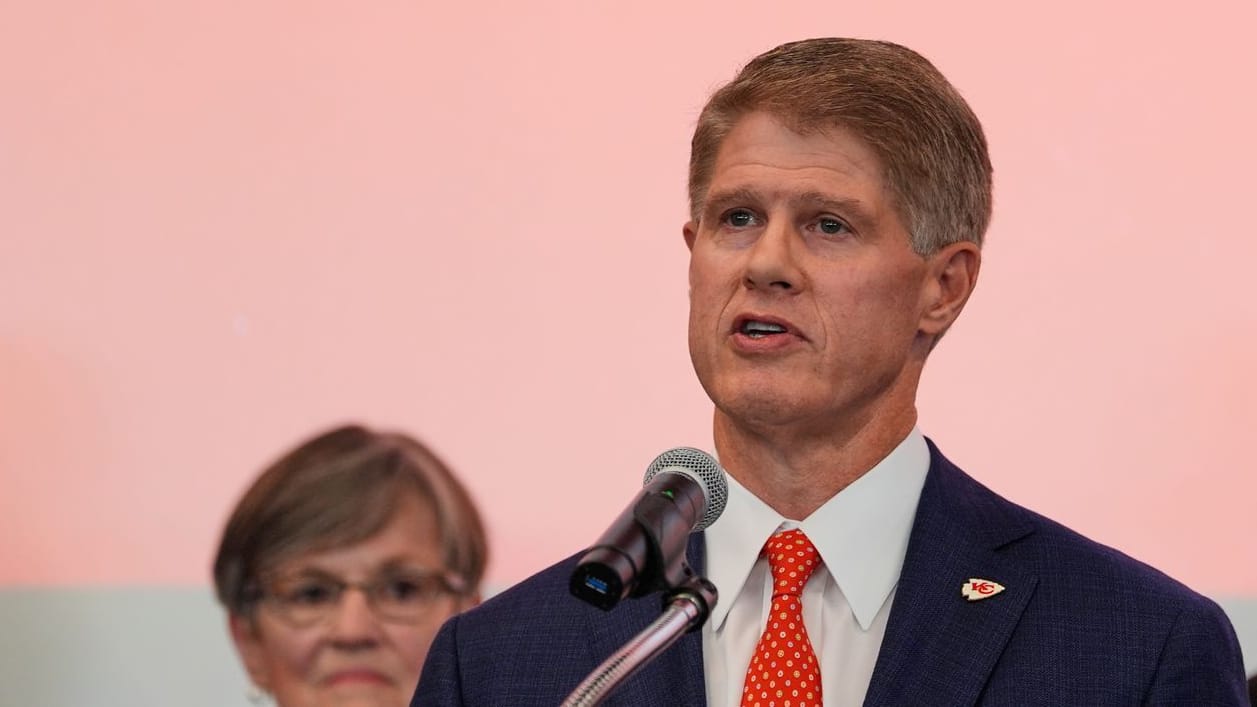 Kansas City Chiefs owner Clark Hunt (center) announces his team's move.