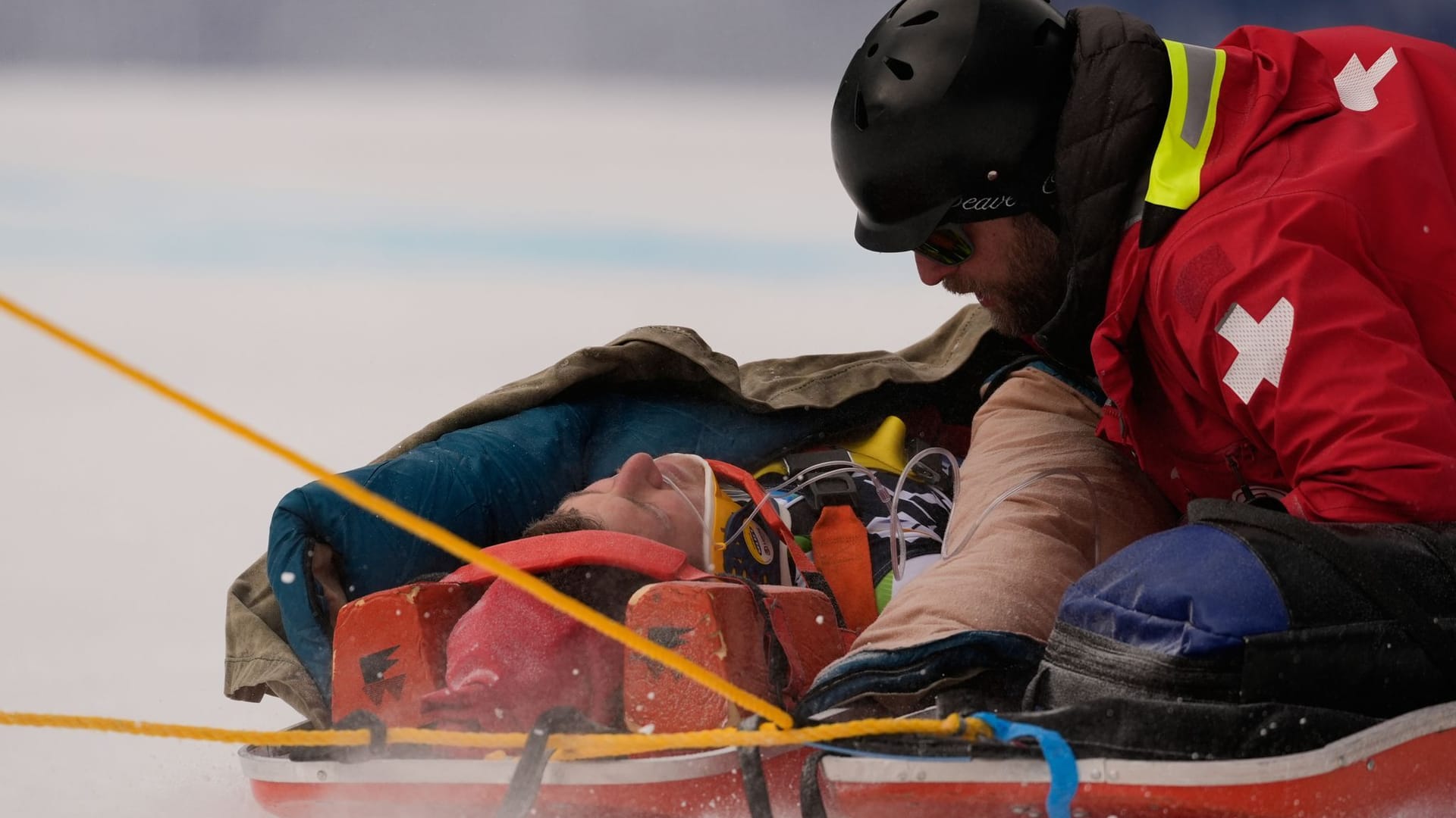 The Slovenian Rok Aznoh is transported away on a sled after a fall.