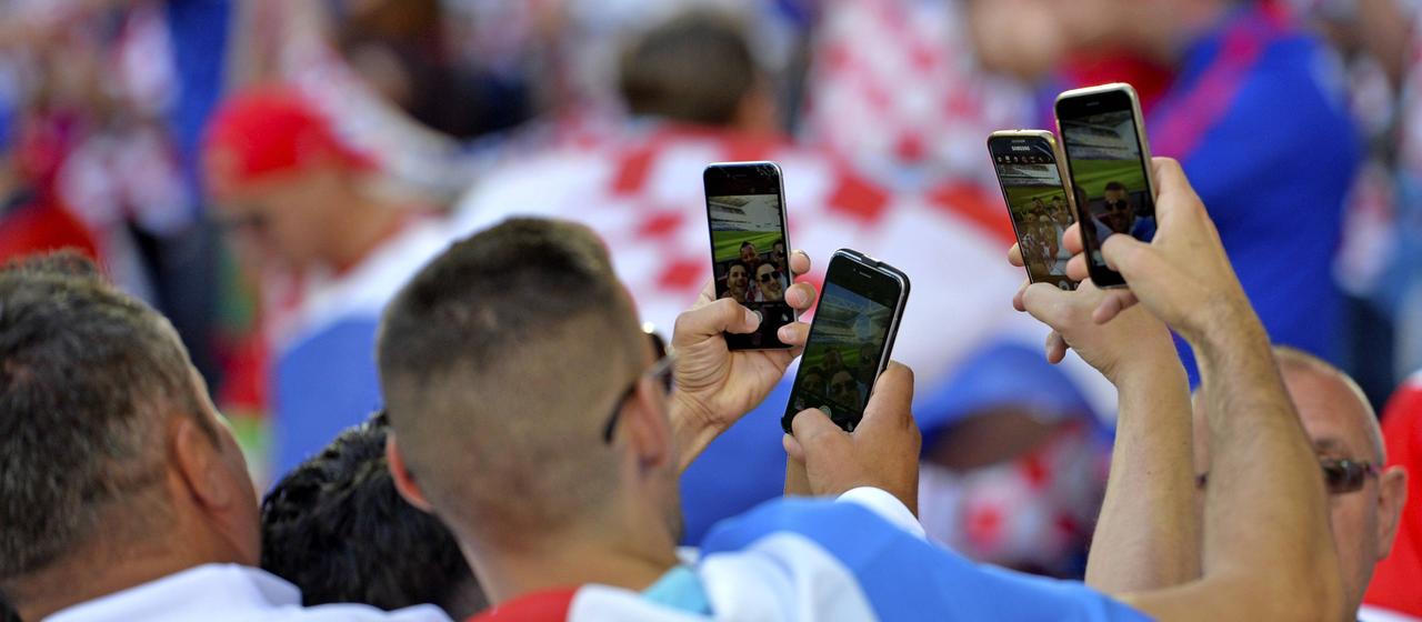 Football fans with cell phones