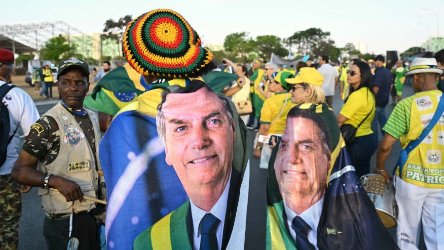Photogallery Supporters of former Brazilian president Jair Bolsonaro, wrapped in flags with his image, participate in a march calling for amnesty for those convicted of attempted coup d'état in Brasilia