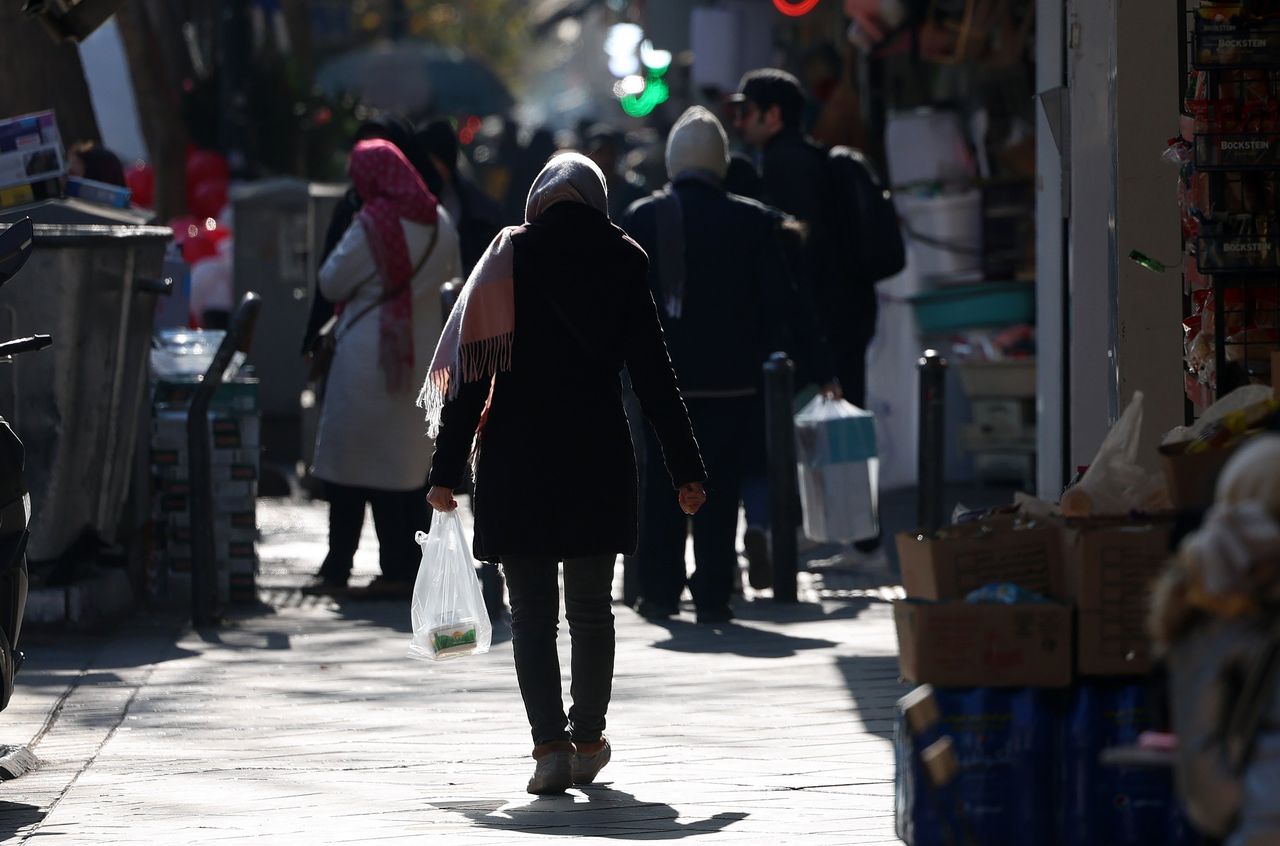 A woman shopping on the street in Tehran on December 31, where protests have been going on for days due to skyrocketing inflation.