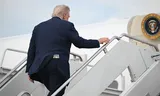 A fifty dollar bill is seen in US President Donald Trump's back pocket as he boards Air Force One on May 1, 2025. 
