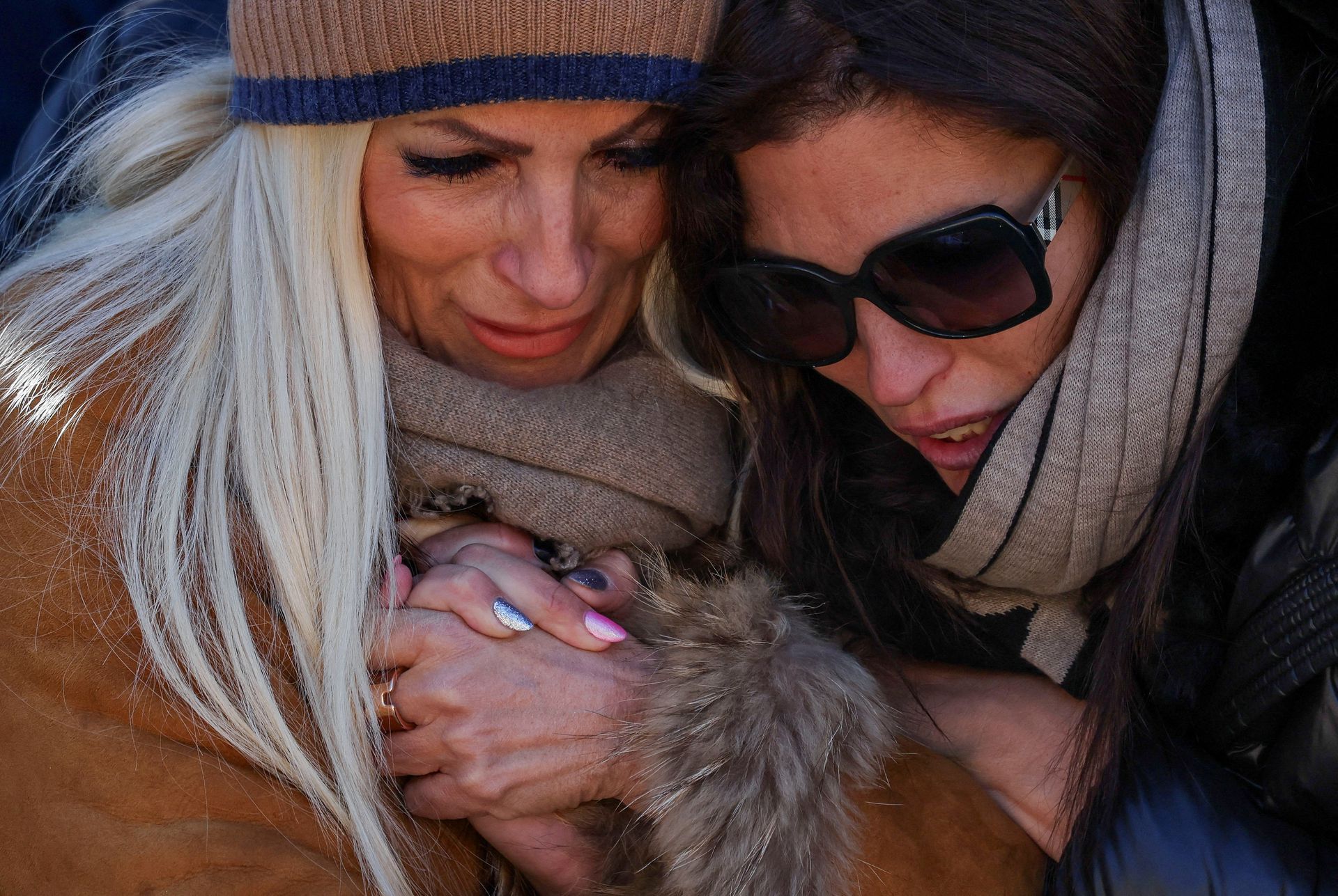 People mourn the victims of the fire on New Year's Eve at a memorial site near the bar Le Constellation in Crans-Montana, Switzerland.
