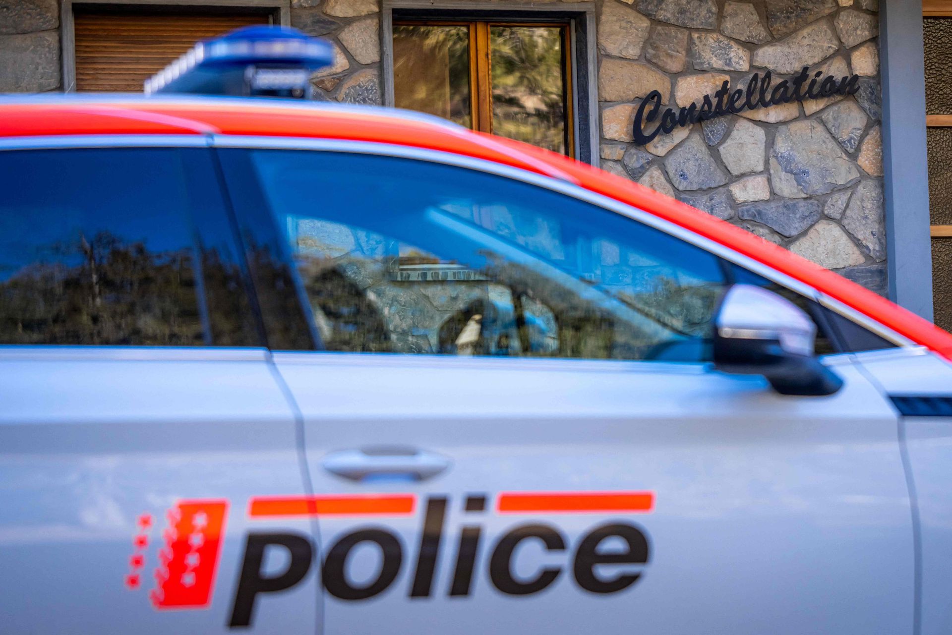 A police car stands at the entrance of bar Le Constellation in Crans-Montana, Switzerland on Sunday.