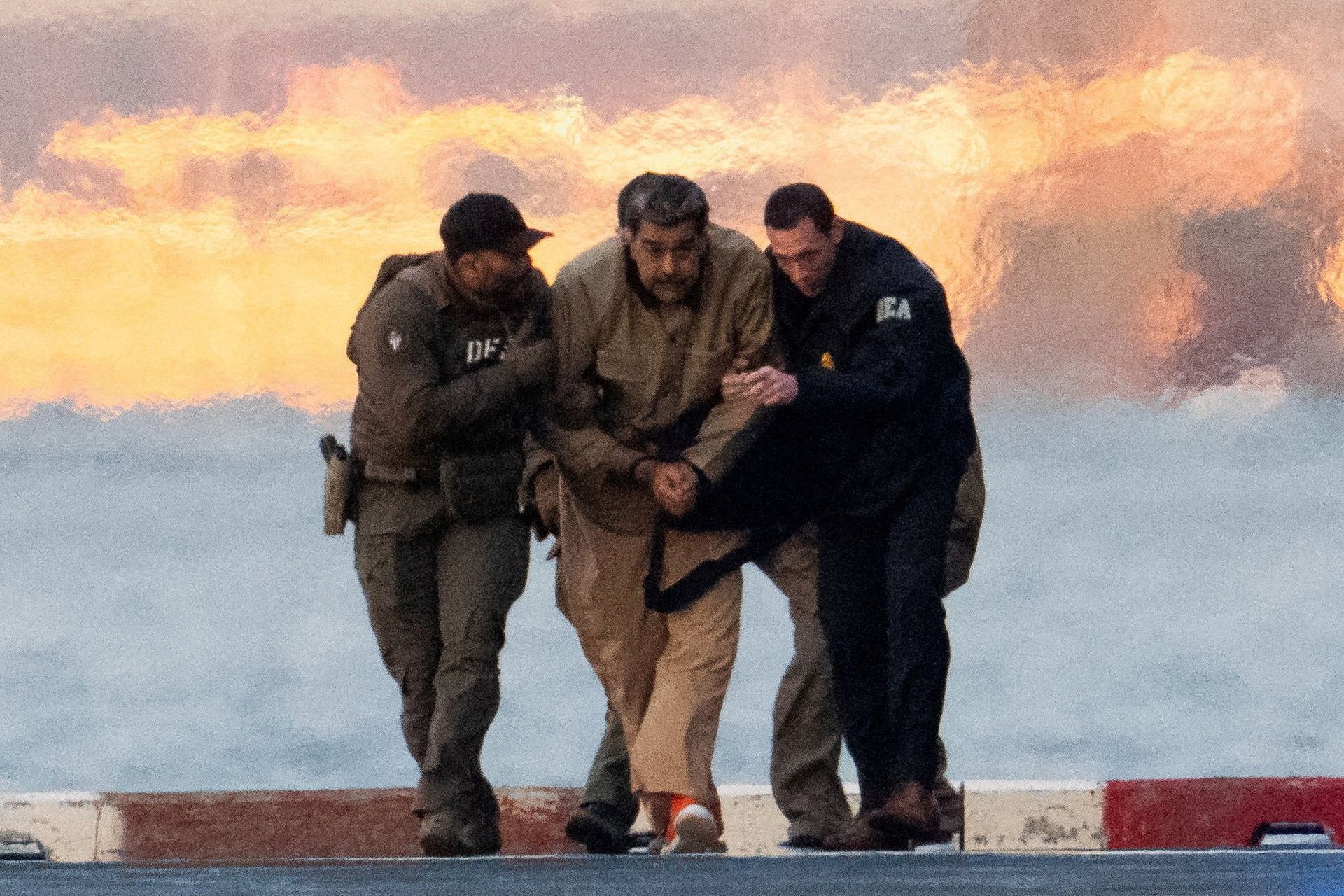 Maduro is escorted from the helicopter by DEA agents upon arrival in New York.      