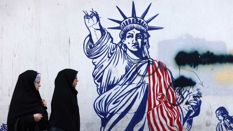 Photogallery Iranian women walk past a mural depicting the Statue of Liberty with her torch-bearing arm broken, painted on the exterior walls of the former US embassy
