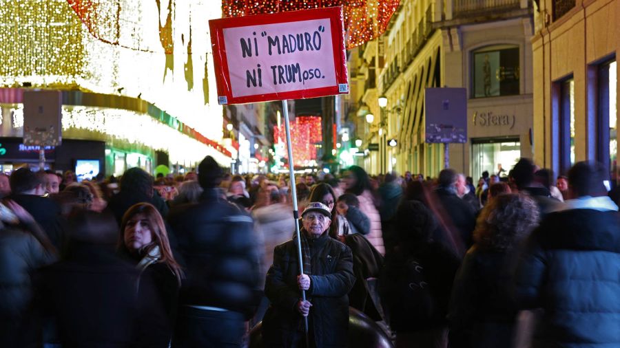 Photogallery A protester holds a banner that says 