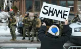 A woman demonstrates on Wednesday in Minnesota at the site where a woman was shot dead earlier in the day by an ICE immigration officer. 