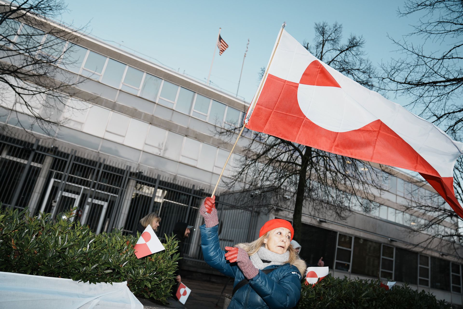 Protesters wave the Greenland flag in front of the US embassy in Copenhagen. 