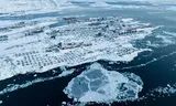 In an inlet near the Greenland capital Nuuk, the houses are covered with snow. 