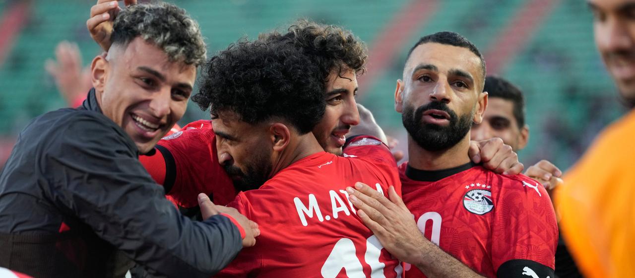 The Egyptian team celebrates after scoring the opening goal against Benin