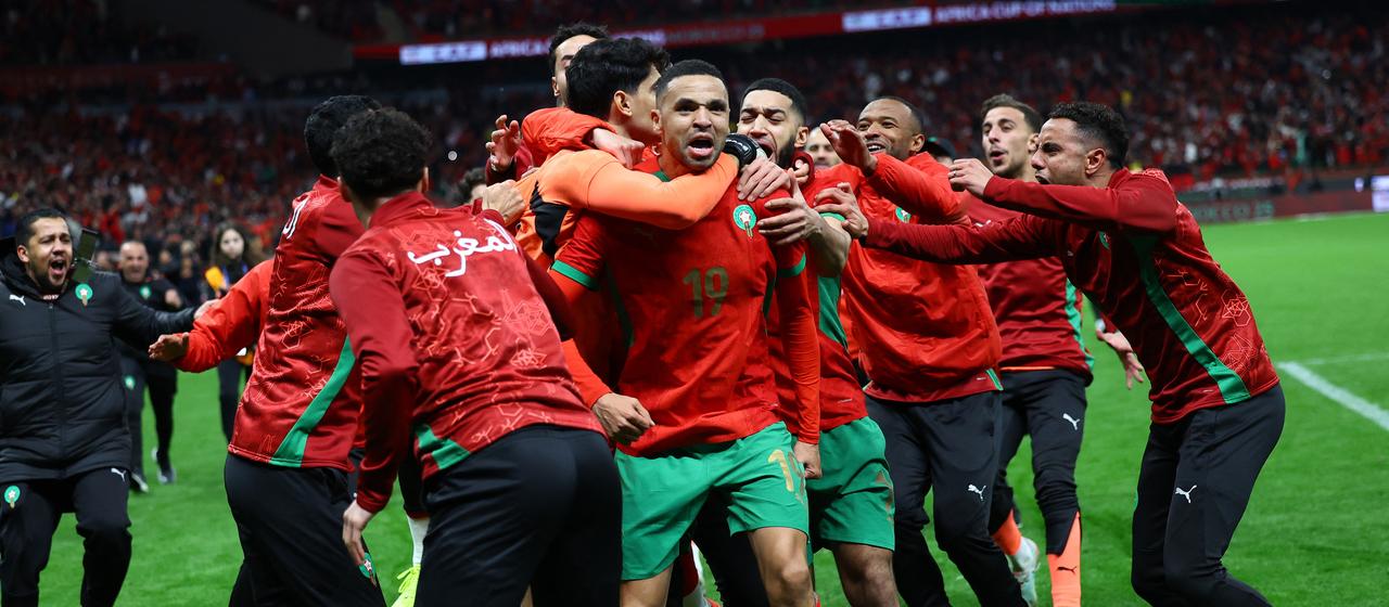 Morocco's players celebrate defeating Nigeria in the Africa Cup semi-finals
