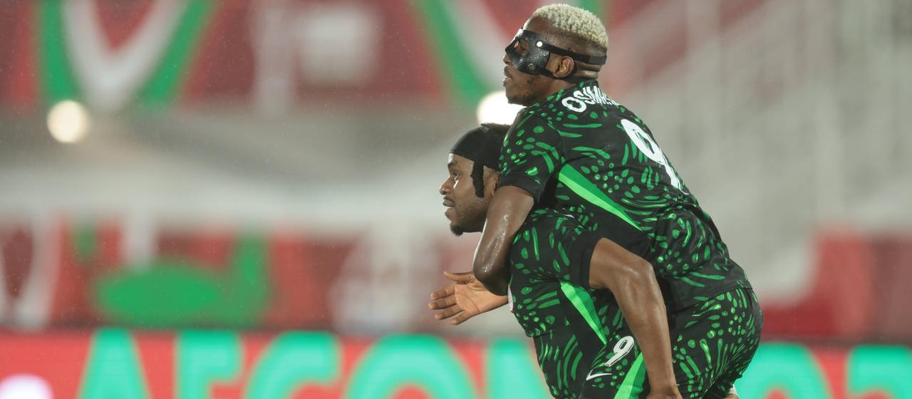 Ademola Lookman and Victor Osimhen celebrate Nigeria's leadership