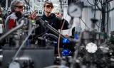 Two researchers at a setup to measure ions from a plasma. The plasma is made by shooting a laser at a plate of tin. The glasses provide protection against (scattered) laser light.