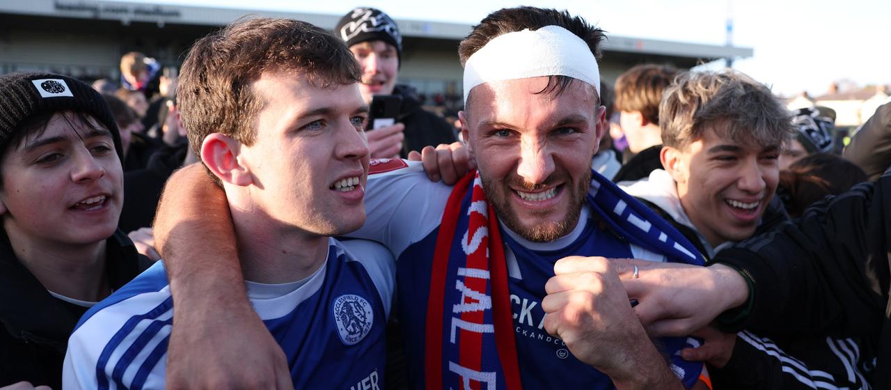 Macclesfield Town's Paul Dawson celebrates with the fans after their cup upset against Crystal Palace 