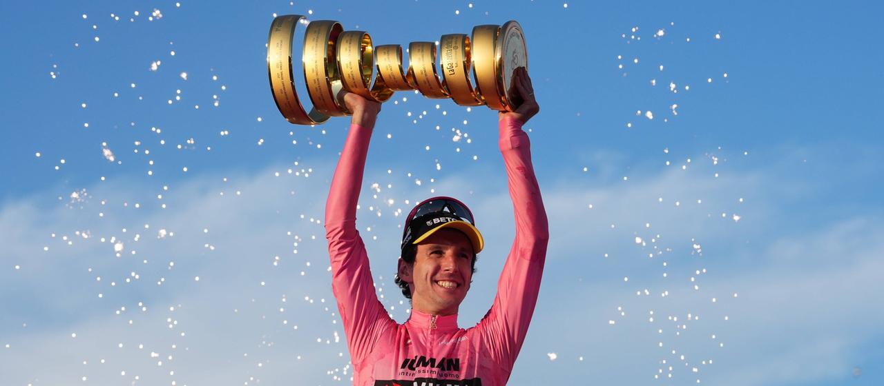 Simon Yates celebrates winning stage 21 with the Giro d'Italia trophy