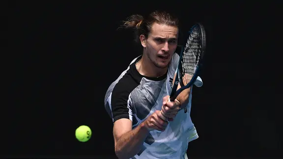 Alexander Zverev hits a tennis ball.