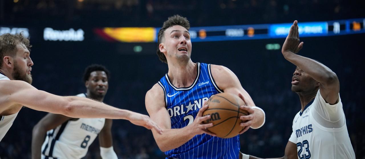 Orlando Magic's Franz Wagner surrounded by Memphis Grizzlies Jock Landale and Cedric Coward