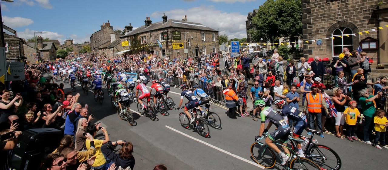 Spectators cheer the cyclists of the Tour de France Britain in Leeds
