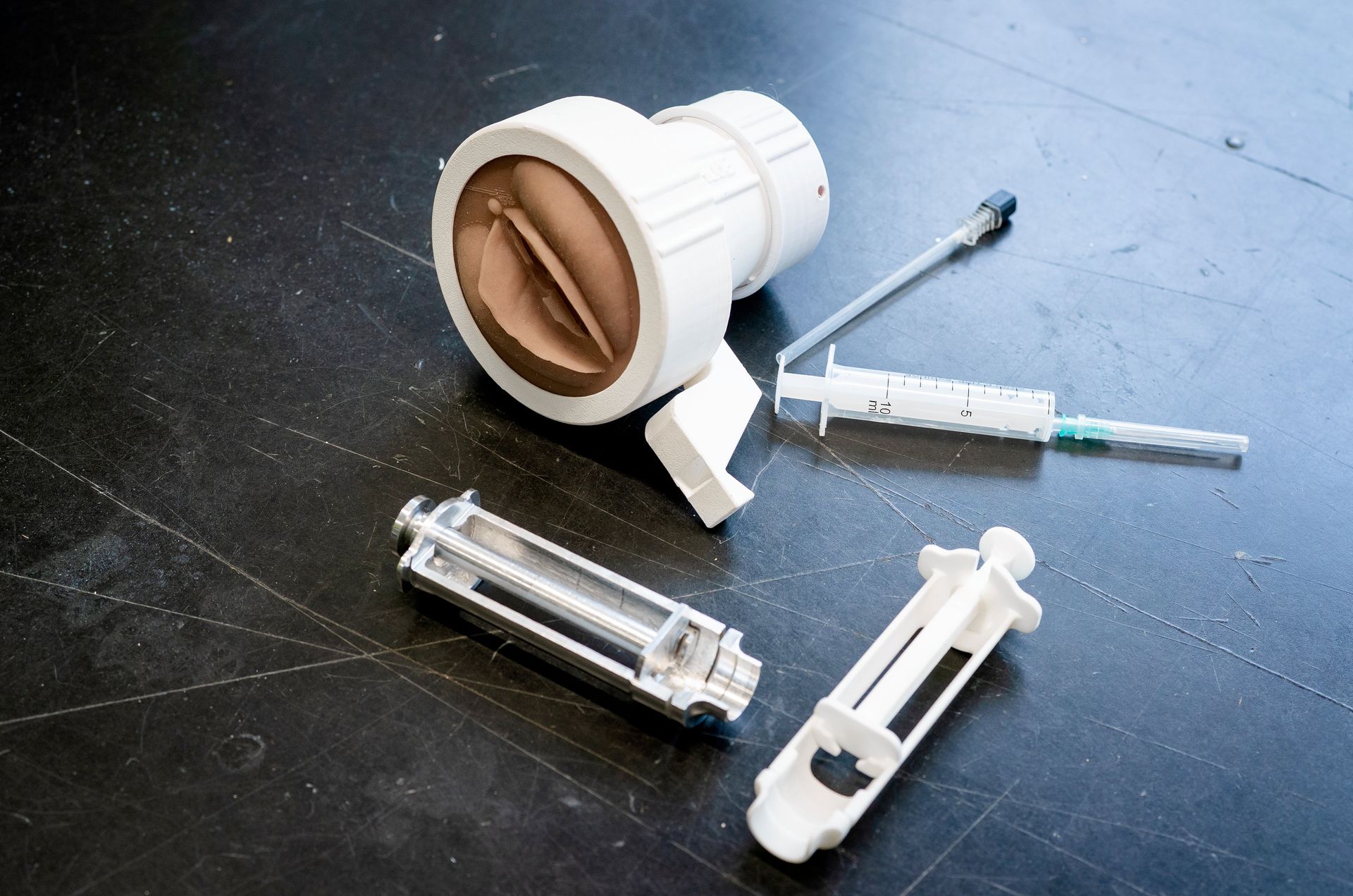 The medical instruments that Samenjo developed: a training model, and two versions of the Chloe, a metal and polypropylene.