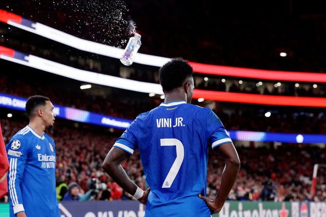 Vinicius Jr gets a bottle thrown to him from the crowd as he is ready to take a corner kick. 