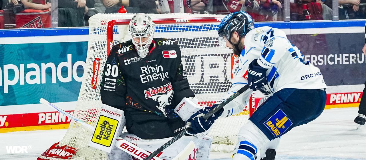 Haie keeper Janne Juvonen in a duel with Riley Barber.