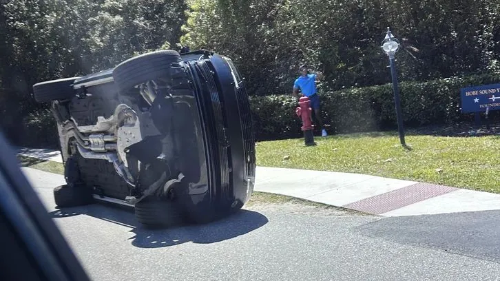 Accident: Tiger Woods is standing next to his SUV, which has tipped over on its side, and is talking on the phone. Accident: Tiger Woods is standing next to his SUV, which has tipped over on its side, and is talking on the phone.